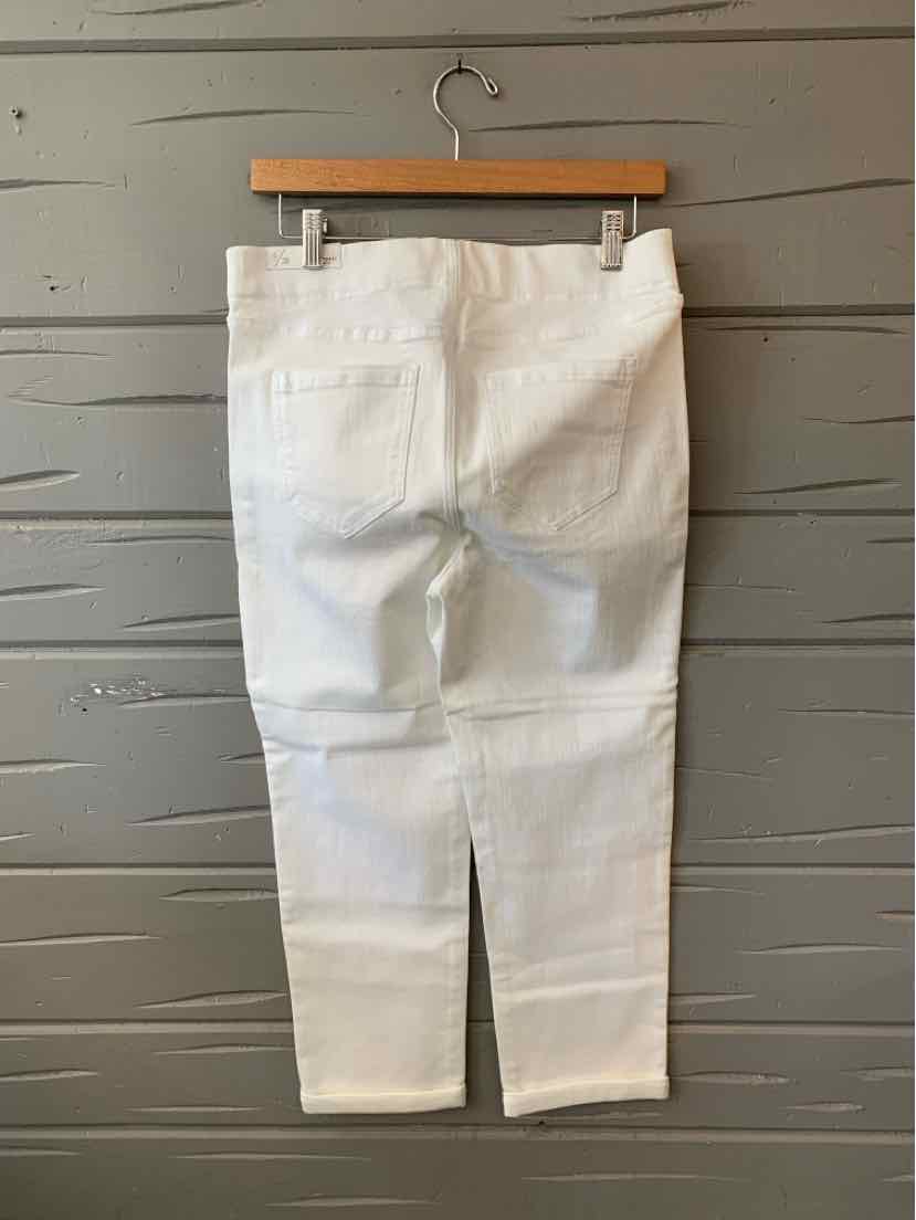 White denim women's pants with back pockets, straight leg cut, size 6, hanging on wooden hanger.