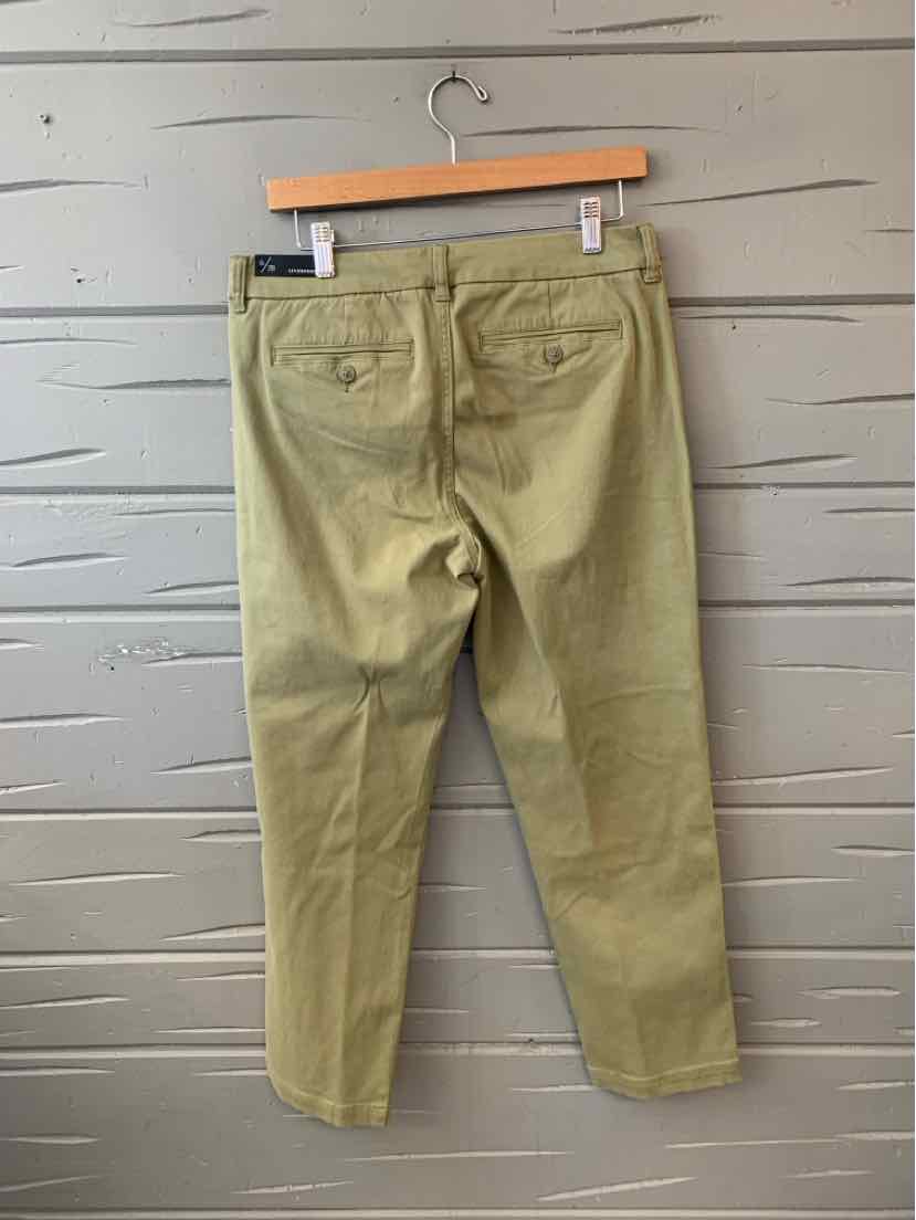 Olive green straight-leg pants with back pockets and belt loops hanging on wooden hanger.