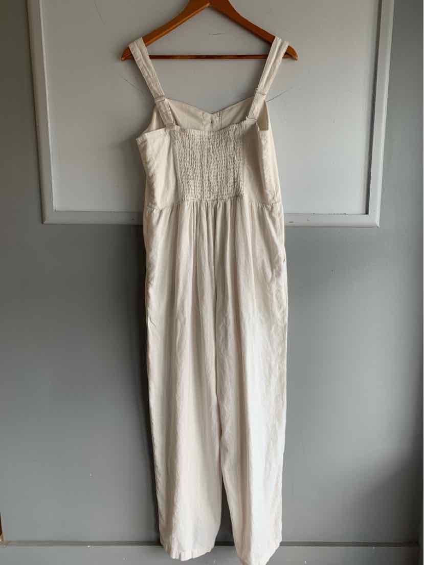 Tan linen blend wide-leg jumpsuit with adjustable straps and gathered waist.