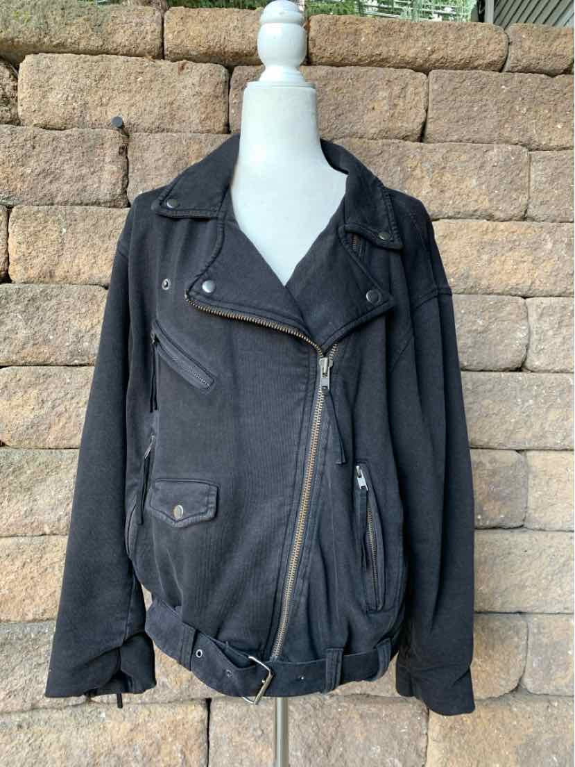 Black asymmetrical zip-front jacket with lapel collar and zippered pockets on a white mannequin.