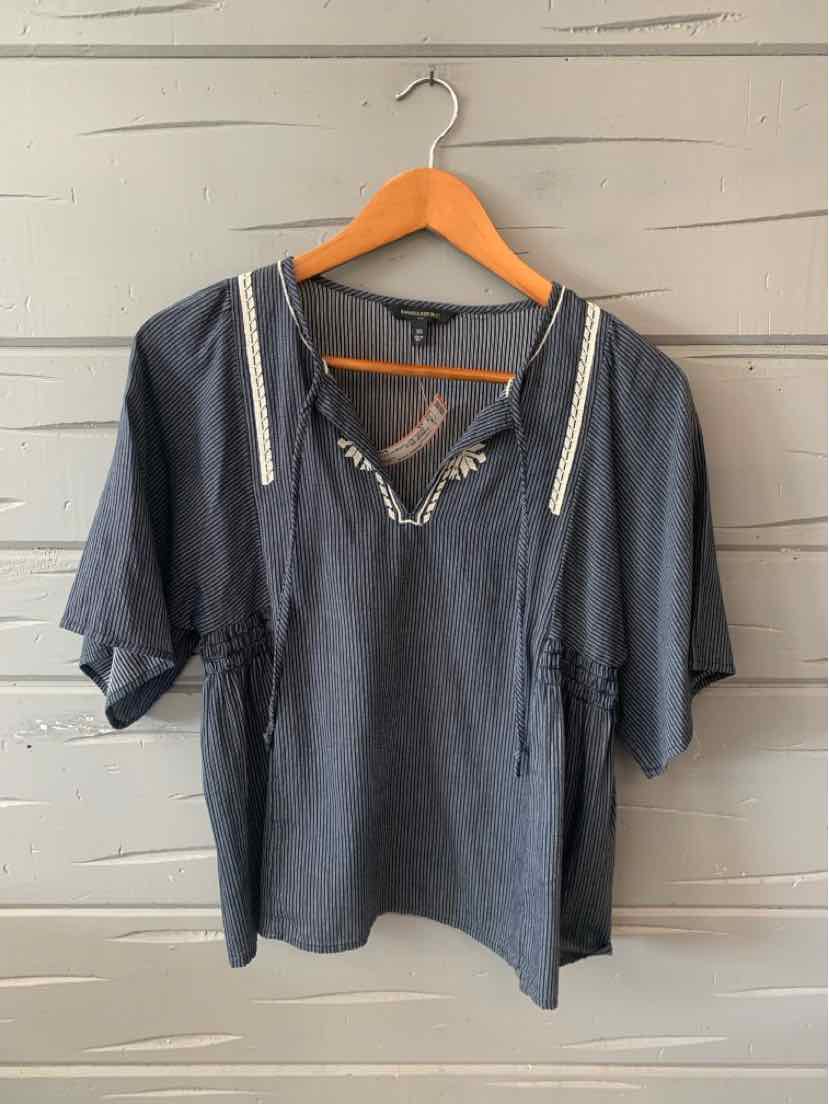 Navy blue blouse with white striped trim, short sleeves, relaxed fit, and v-neck with laces.