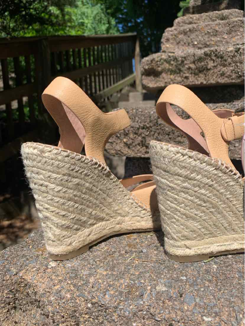 Tan wedge sandals with woven jute platform heels and ankle straps, size 7.