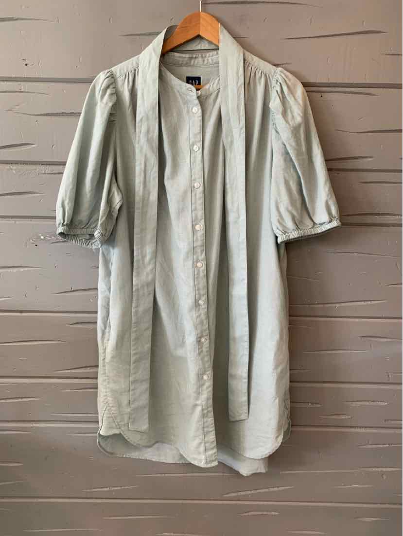 Light mint green button-up shirt dress with puffed elbow-length sleeves on wooden hanger.