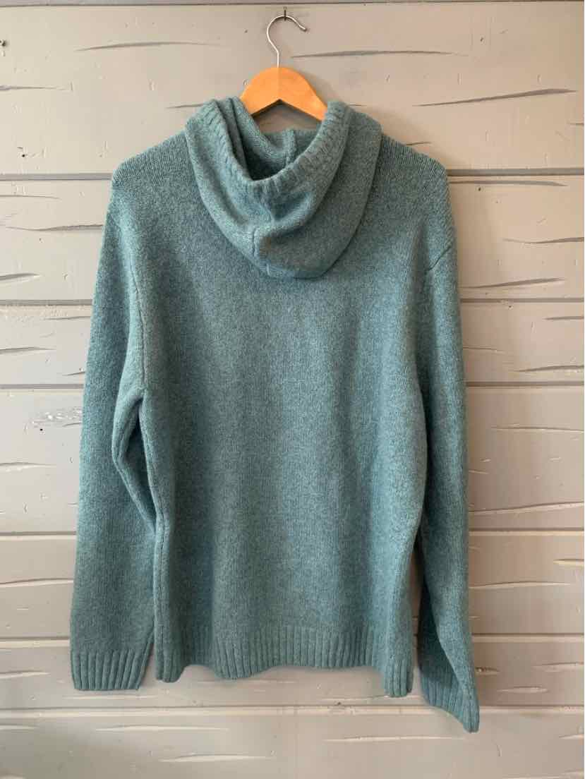 Light teal knitted sweater with a loose turtleneck and long sleeves, size XL, hanging on wooden hanger.