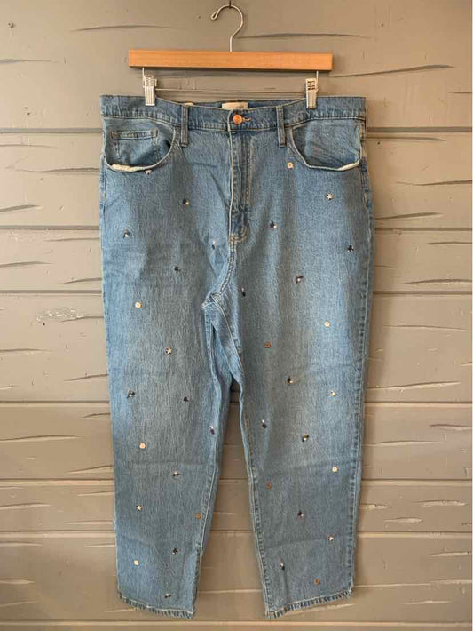 Light blue denim jeans with floral embroidery and high waist, straight leg fit.