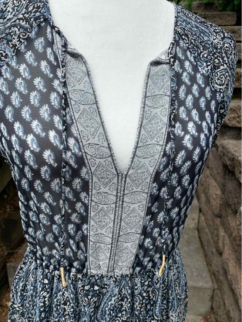 Navy paisley tunic with deep V neckline and geometric trim on collar and chest.