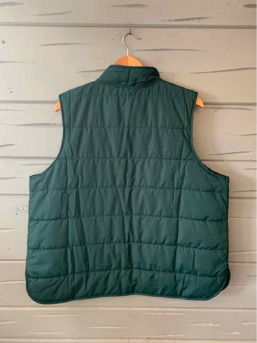 Dark green quilted sleeveless vest with stand collar, size 1X, hanging on wooden hanger.
