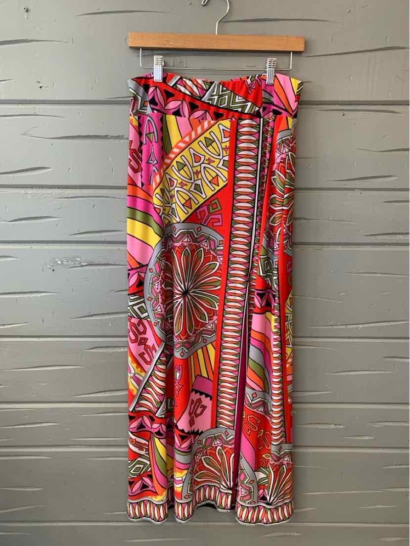 Colorful wide-leg pants with bold geometric and floral prints in red, pink, yellow, and orange hues.