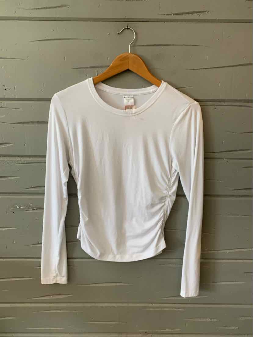 White long-sleeve crewneck athletic shirt with smooth, fitted fabric hanging on wooden hanger.