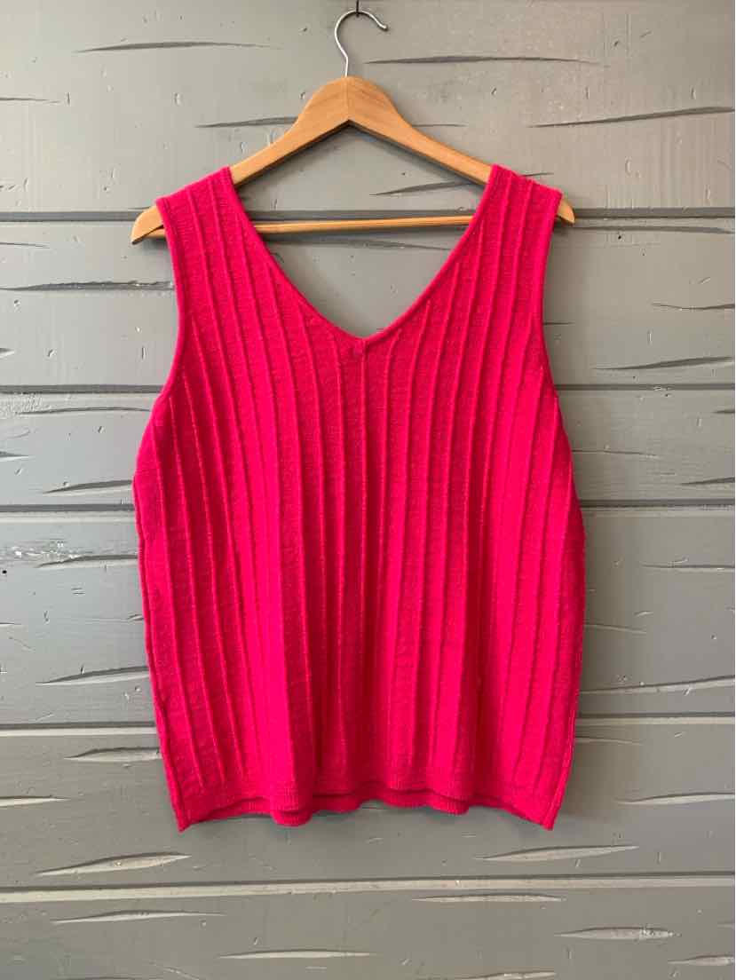 Bright pink sleeveless knit top with vertical ribbing and V-neck on wooden hanger.