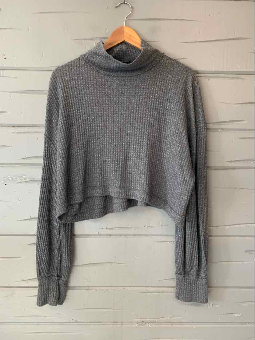 Gray waffle-knit cropped turtleneck sweater with long sleeves and ribbed cuffs.