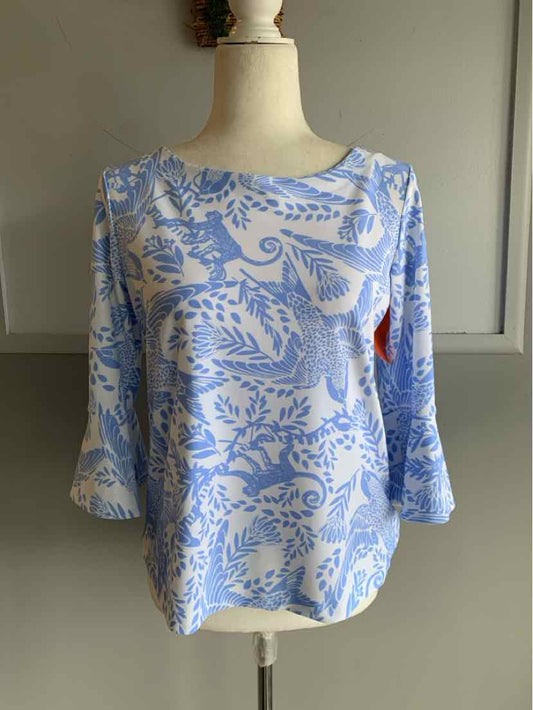 Light blue blouse with white floral and paisley pattern, three-quarter sleeves, round neckline.