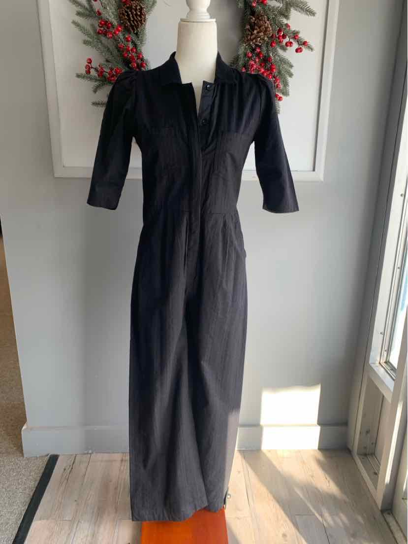 Black midi dress with three-quarter sleeves and a deep V-neckline on a dress form.