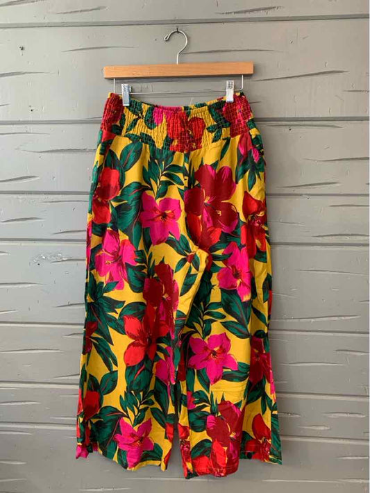 Yellow wide-leg pants with large red and pink floral print, lightweight fabric, elastic waist.