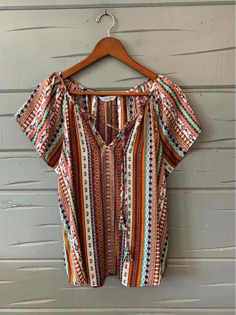 Boho-style blouse with multicolor vertical stripes and short puff sleeves on wooden hanger.