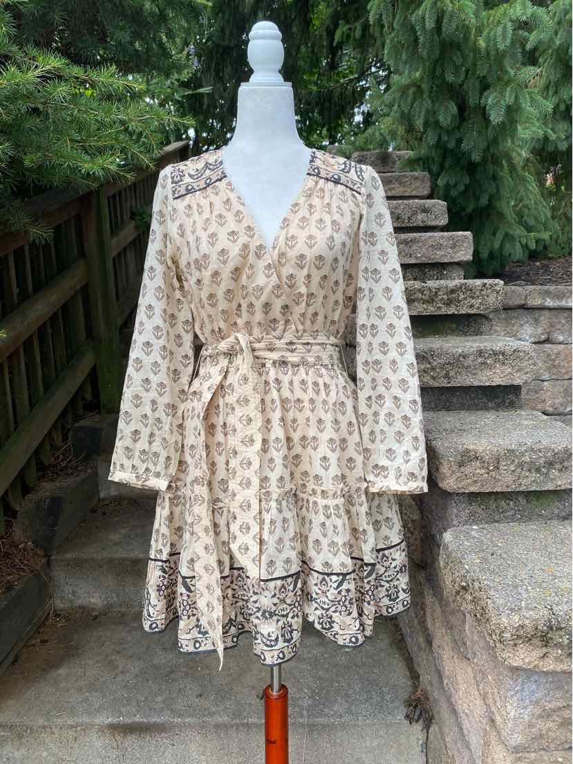 Beige floral print wrap dress with long sleeves and tiered ruffle hem, lightweight fabric.