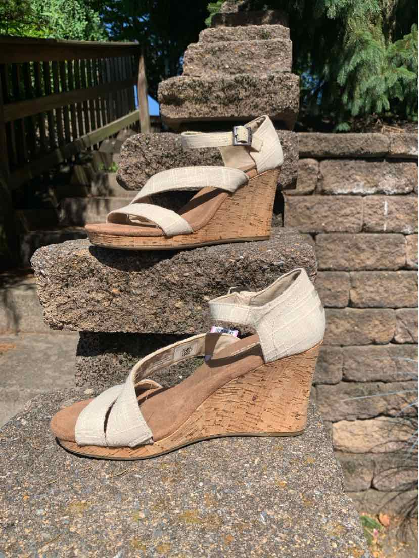 Beige canvas wedge sandals with ankle strap and cork platform sole, size 7.