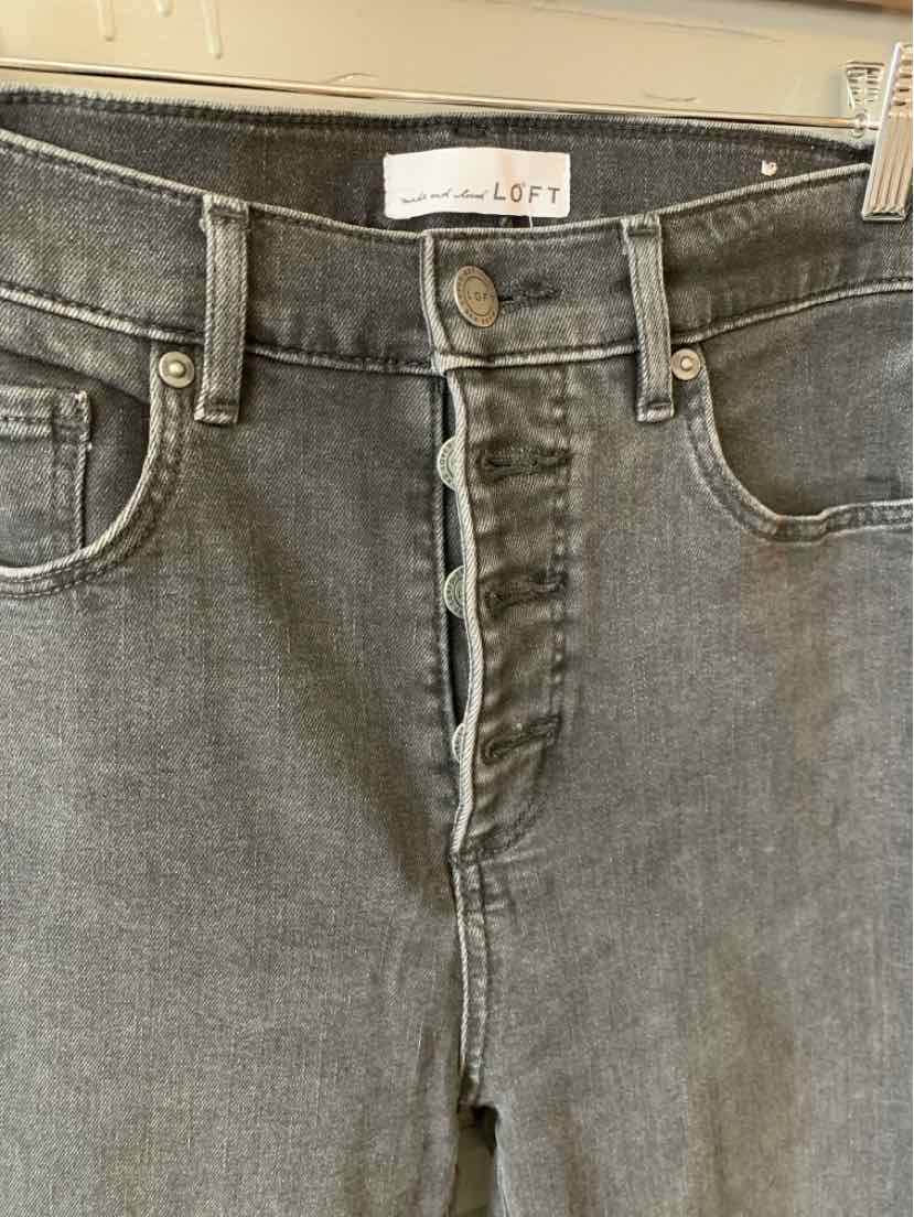 High-waisted dark gray denim jeans with button fly and front pockets, size 8.