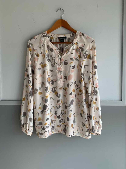 Cream long-sleeve blouse with abstract brown and black pattern, gathered neckline and cuffs.