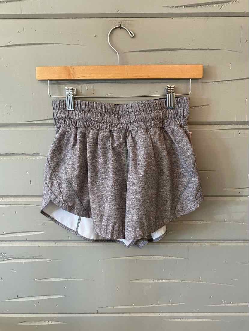 Gray Lululemon athletic shorts with elastic waistband and white trim on curved hem.