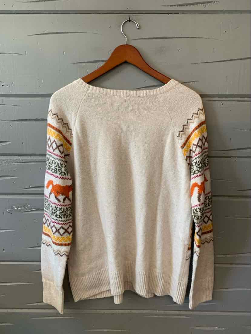 Ivory Talbots knit sweater with a boat neckline and colorful geometric patterned sleeves.
