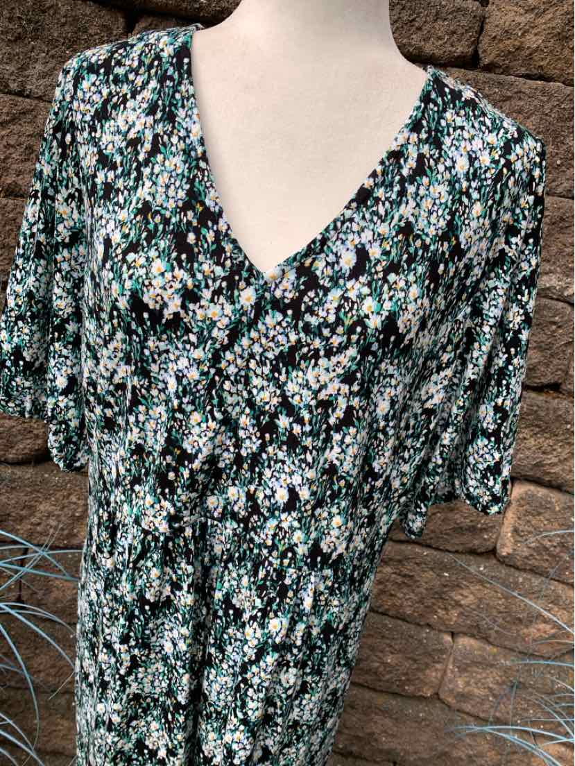 Floral print blouse with short sleeves and V-neck in green, black, and white colors.