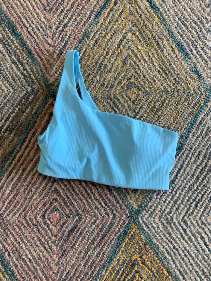Light blue one-shoulder sports bra with smooth fabric and seamless design by Lululemon, size 6.