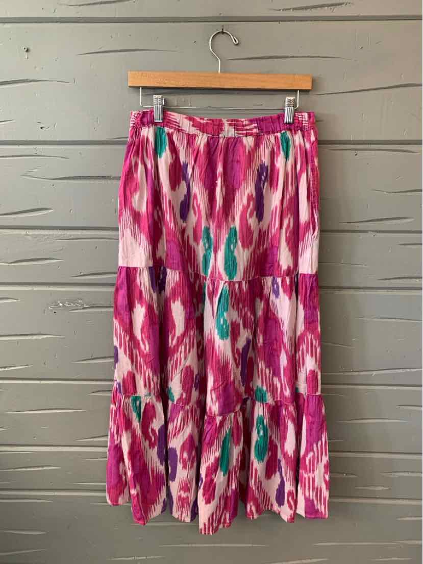 Pink and purple ikat patterned midi skirt with elastic waistband and tiered design.