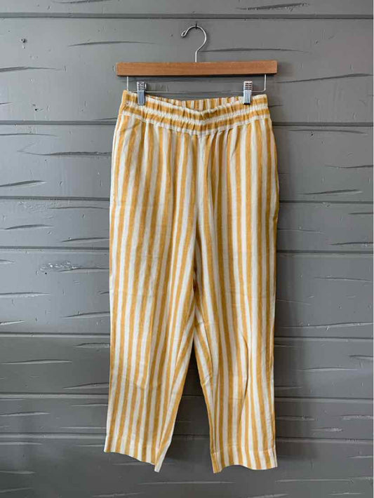 Yellow and white vertical striped high-waist wide-leg pants with belt loops and side pockets.