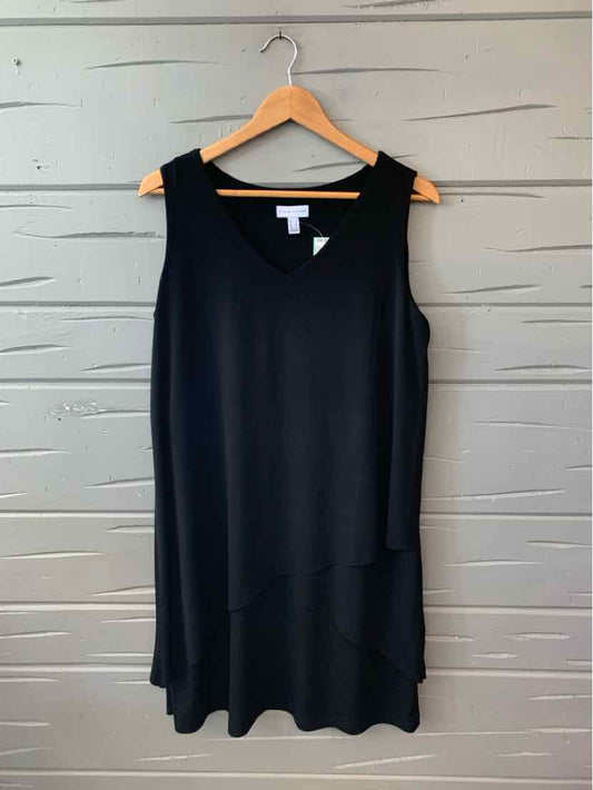 Black sleeveless sleeveless dress with a loose fit and round neckline on wooden hanger.