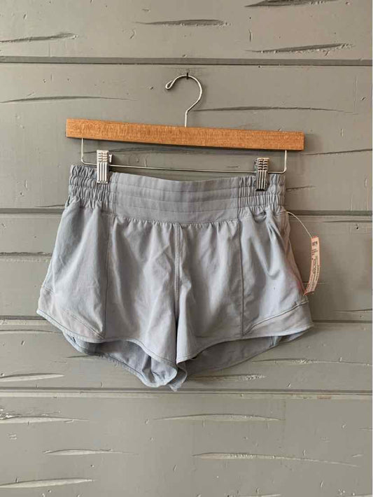 Light gray athletic shorts with elastic waistband and side slits, lightweight fabric.