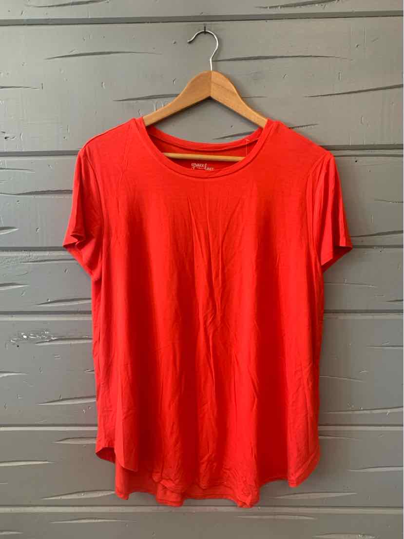 Red short-sleeve relaxed-fit T-shirt with round neckline hanging on wooden hanger.