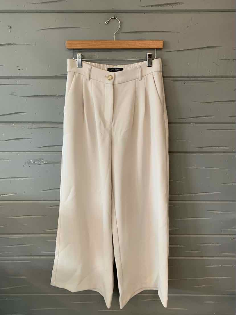 Cream wide-leg pants with front pleats and belt loops, size 4, hanging on wooden hanger.