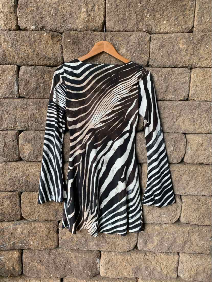Long-sleeve mini dress with black and white zebra print and slightly flared sleeves on wooden hanger.