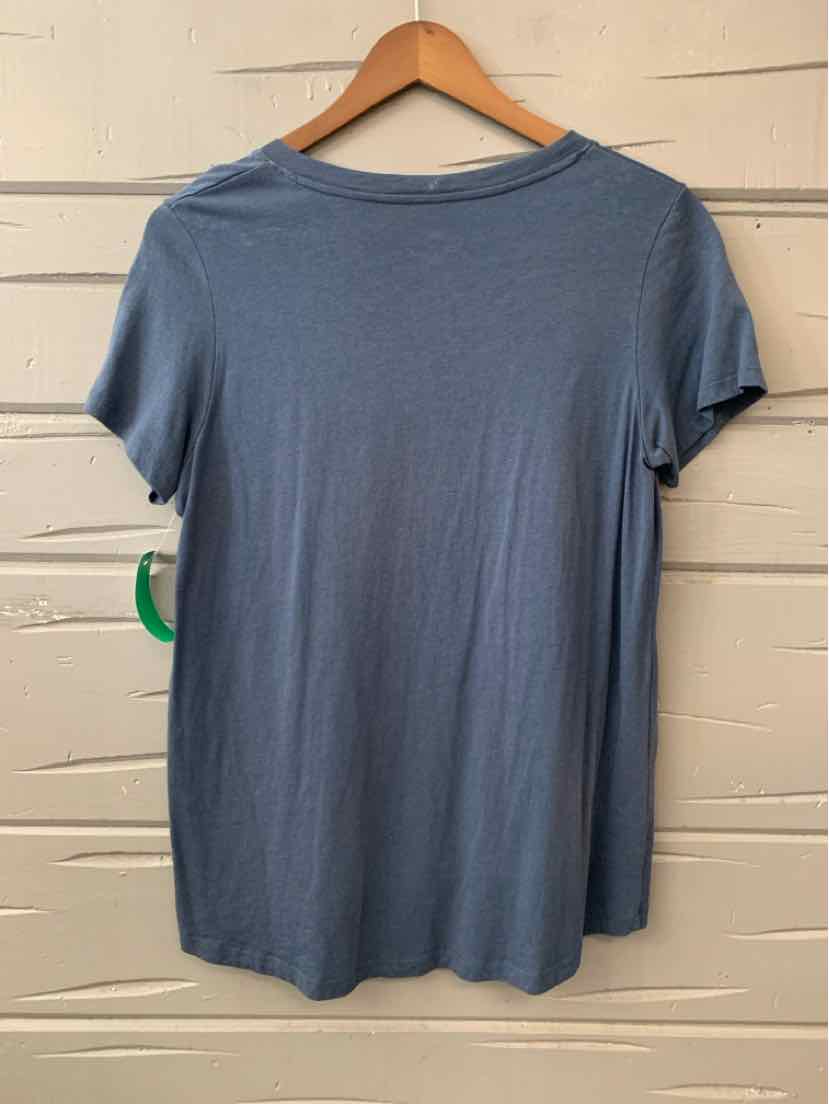 Solid blue short-sleeve crew neck t-shirt hanging on wooden hanger.