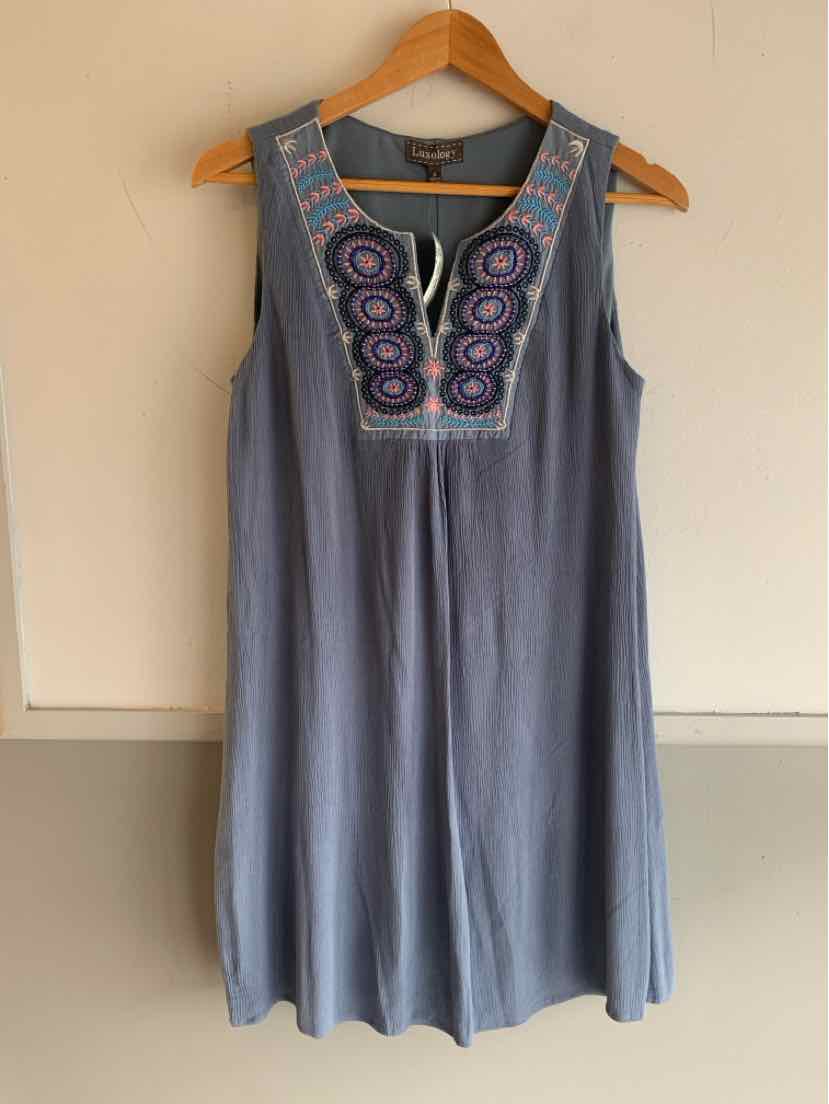 Sleeveless blue dress with multicolored circular embroidery on yoke and keyhole neckline.