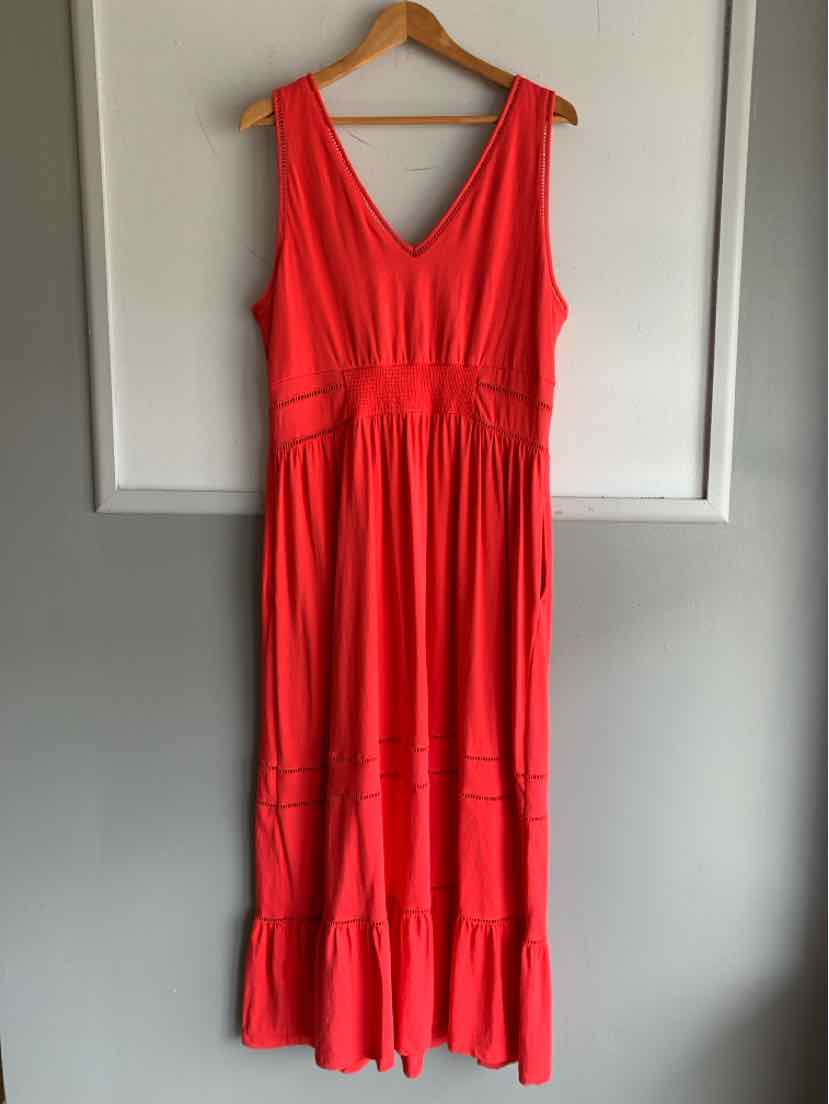 Sleeveless bright red maxi dress with V-neck and gathered waist detailing on wooden hanger.