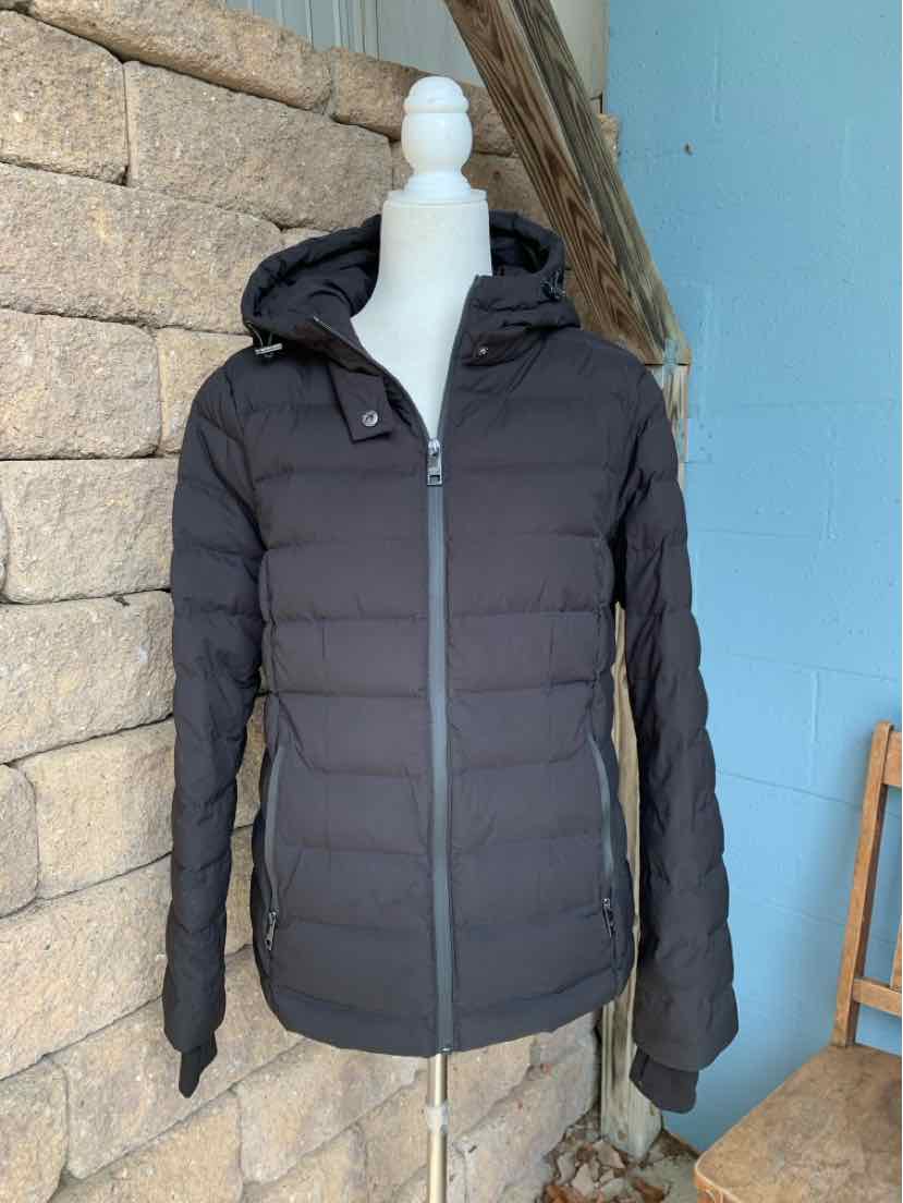 Women’s black Michael Kors puffer jacket with a hood, horizontal quilting, and front zip closure.