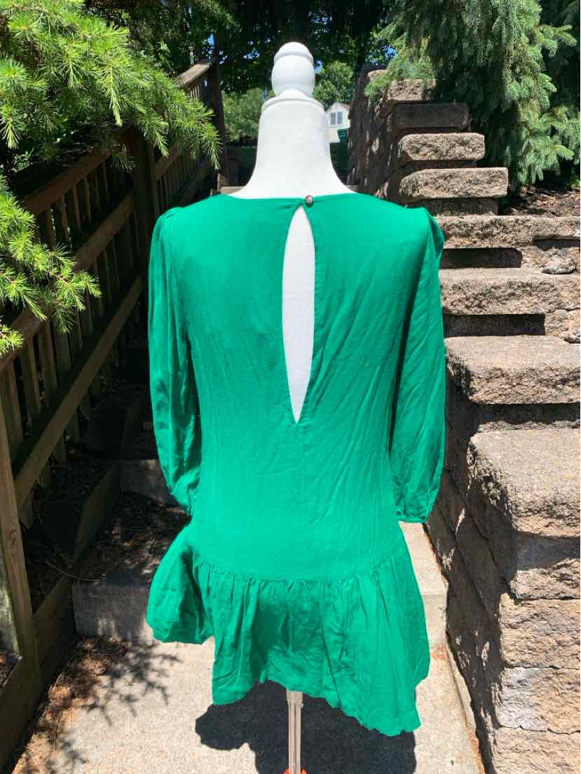 Green knee-length dress with three-quarter sleeves, keyhole back, and ruffled hem.
