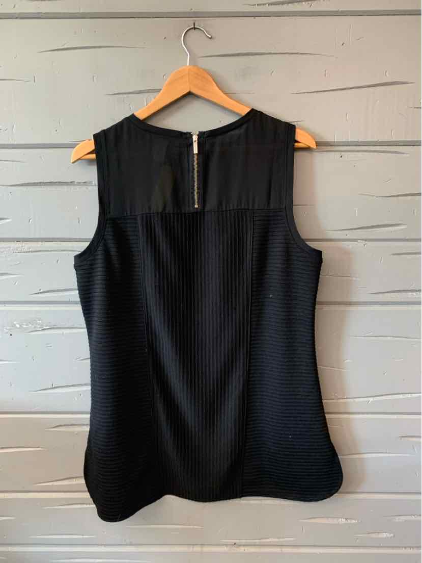 Black sleeveless blouse with sheer yoke and pleated texture, keyhole back with button closure.