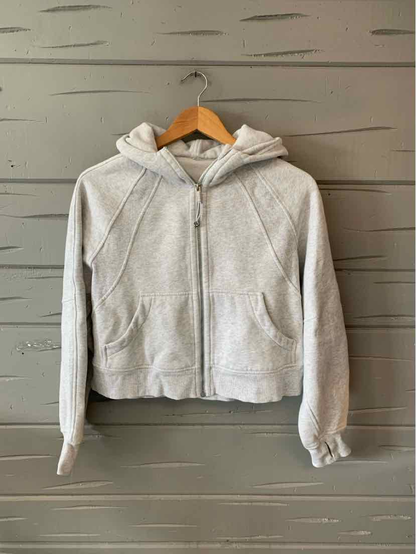 Light gray zip-up hoodie with front pockets and fitted cuffs, made of soft fabric.