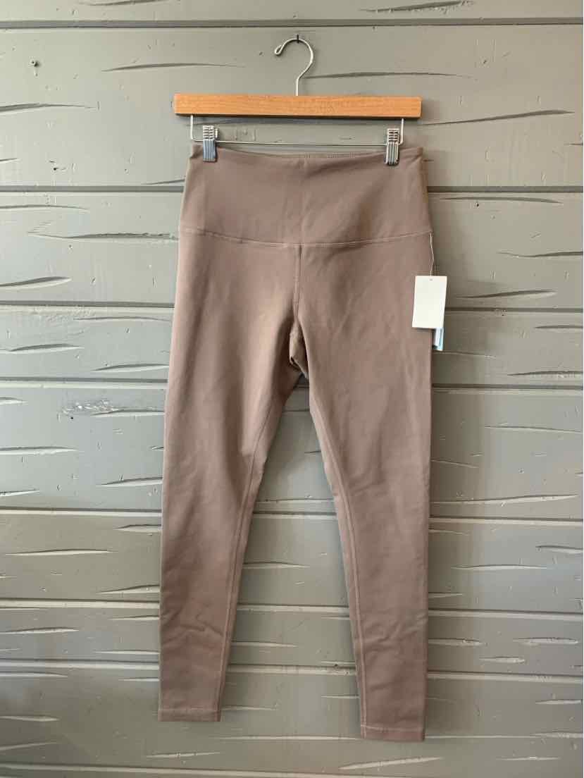 Taupe high-waist seamless leggings with a smooth finish and straight leg cut hanging on wooden hanger.