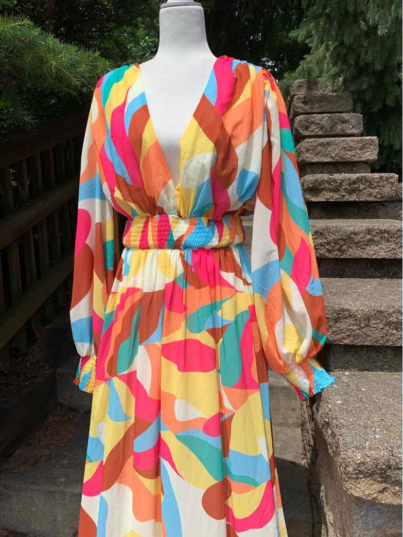 Colorful geometric print long-sleeve dress with V-neck and cinched waist in light, flowy fabric.