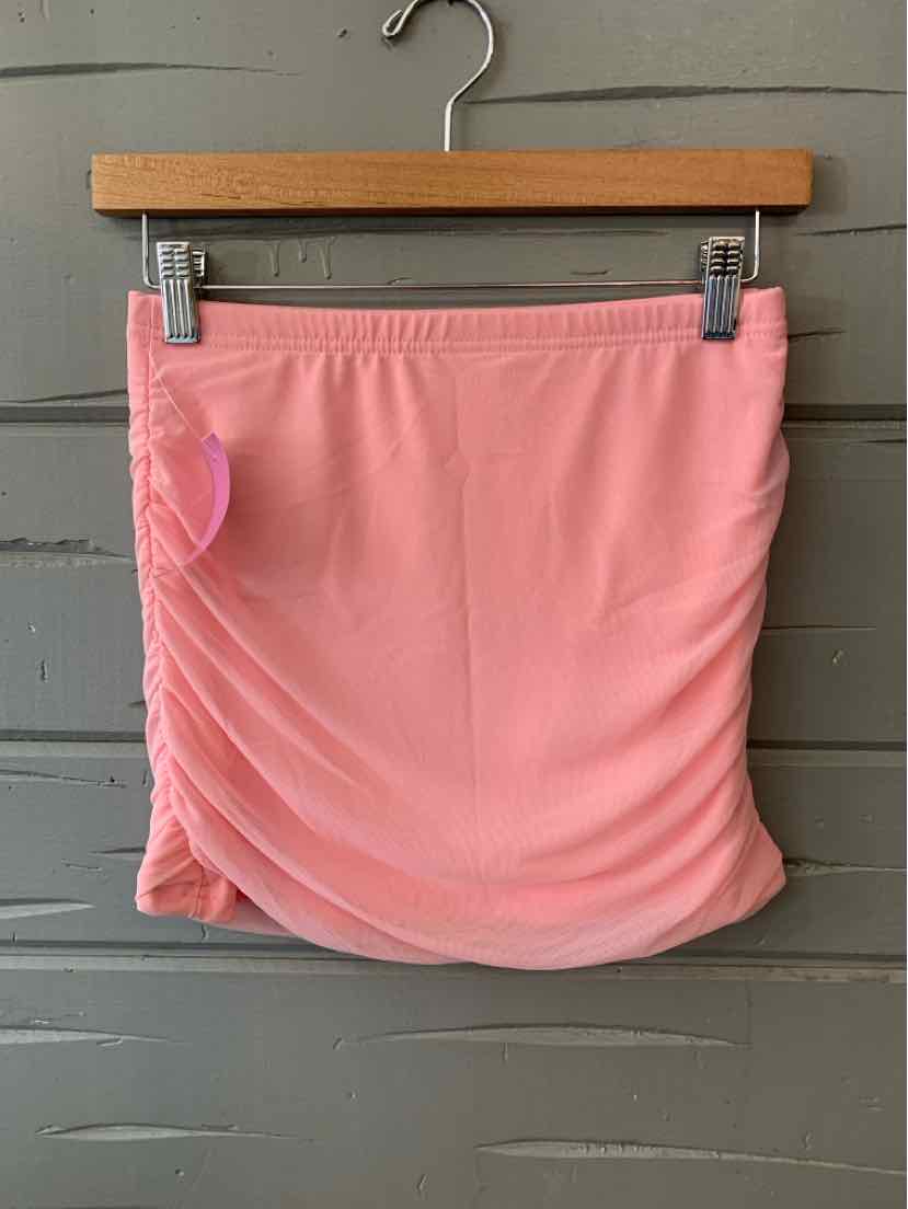 Soft pink mini skirt with ruched detailing on one side, made of lightweight fabric.