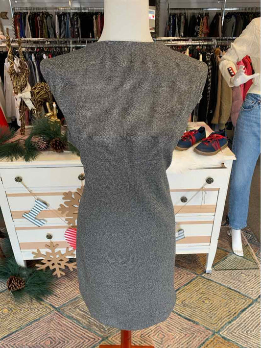 Gray sleeveless tweed dress with fitted silhouette on mannequin.