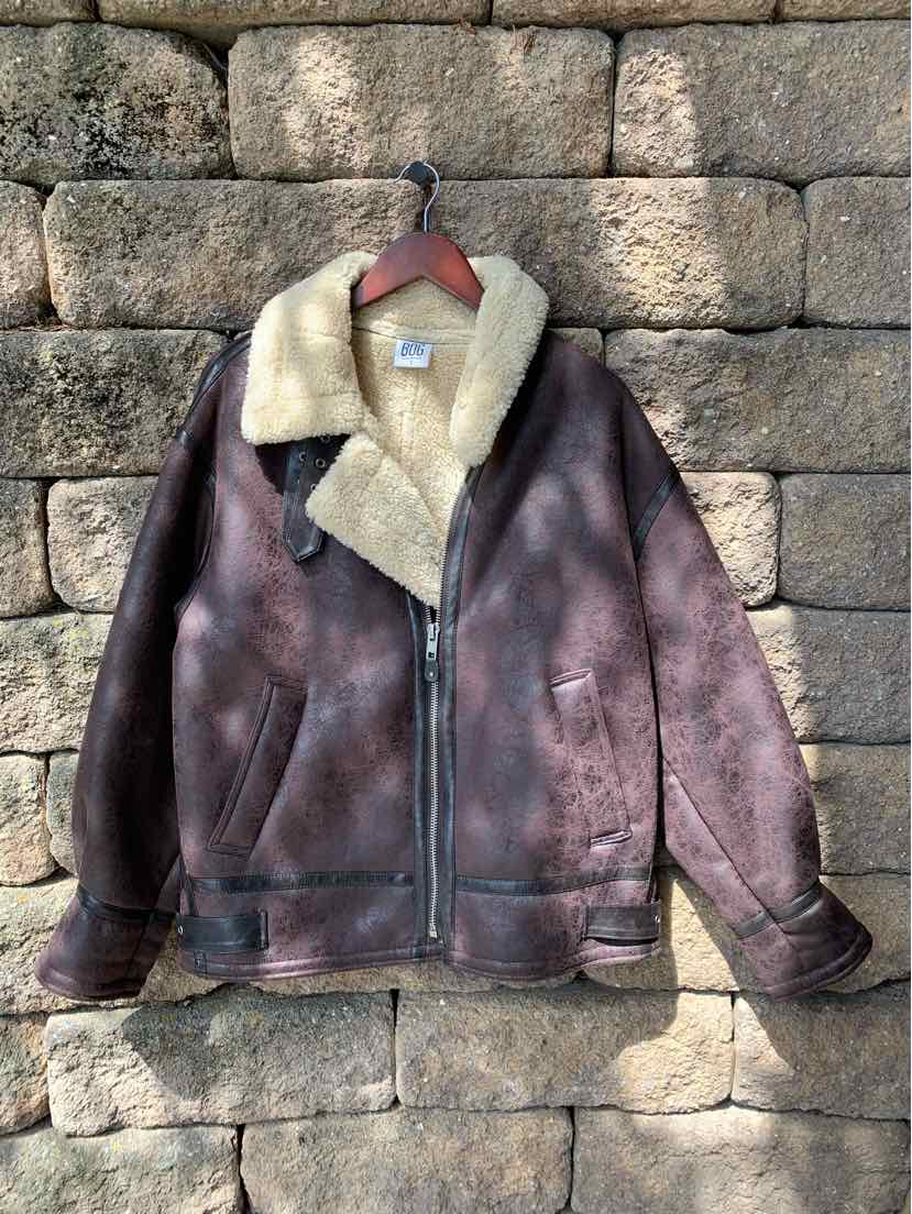 Dark brown suede bomber jacket with cream shearling collar and lining, front zipper and side pockets.