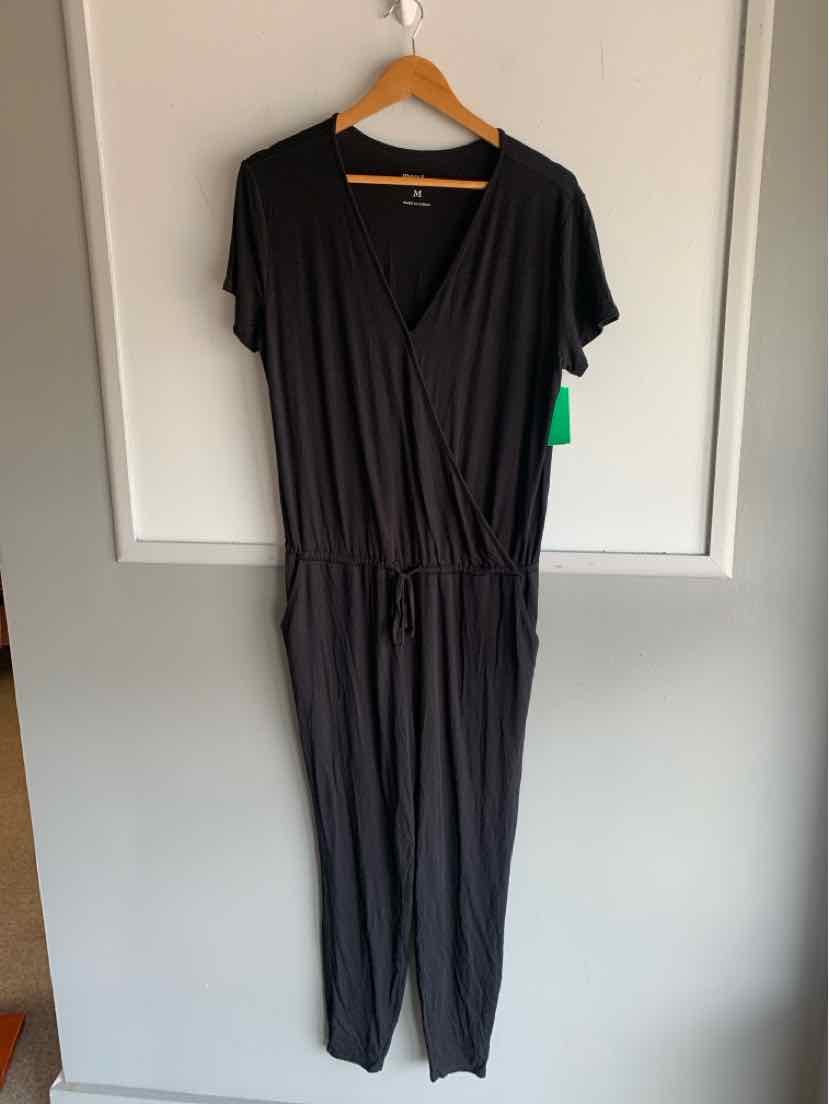 Black short-sleeve jumpsuit with V-neck wrap front and elastic waist, medium size.