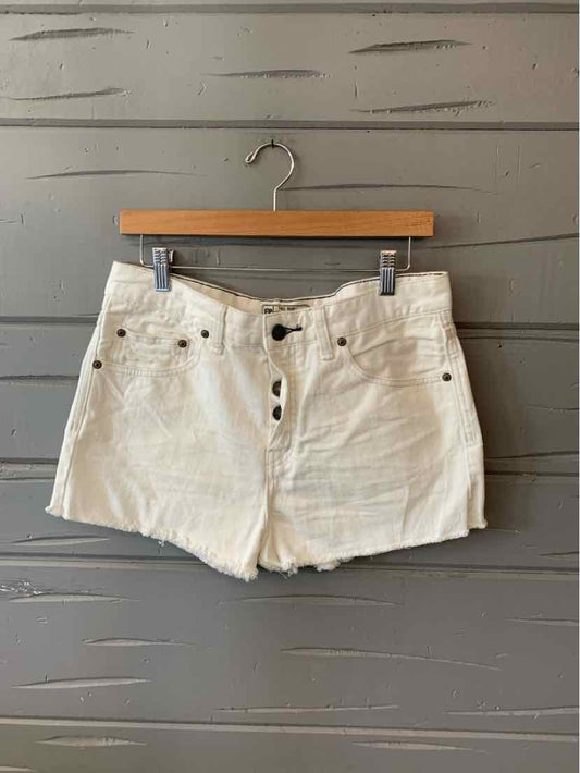 White high-waisted denim shorts with front button closure and belt loops, size 8.