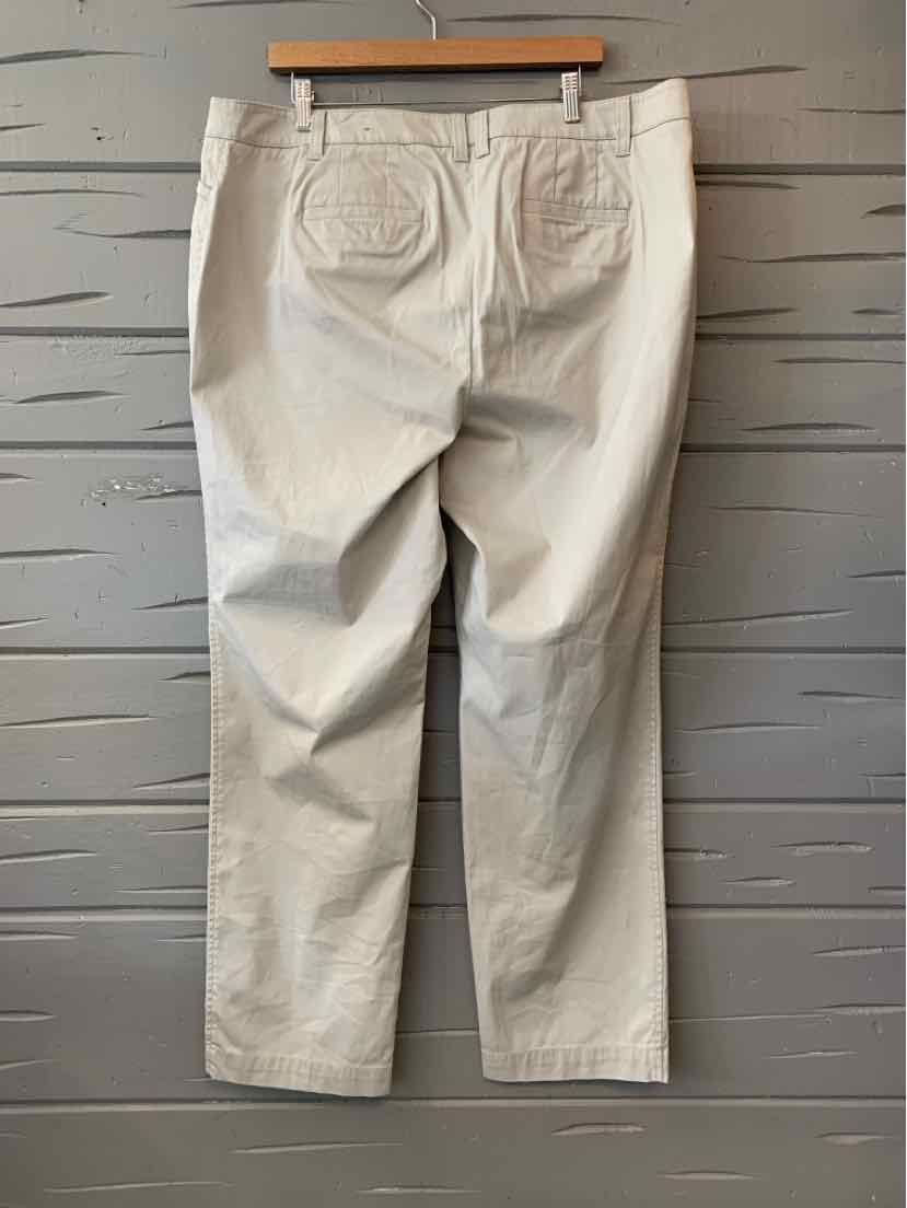 Tan straight-leg pants with back patch pockets and size 16W label on wooden hanger.