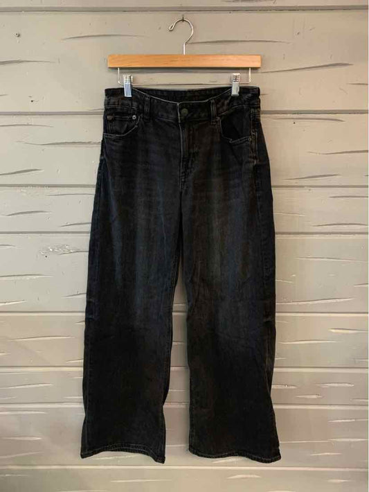 Black bootcut jeans with five-pocket styling and belt loops, size 4.